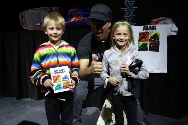 Athlete meet and greet, poster and tee in hand